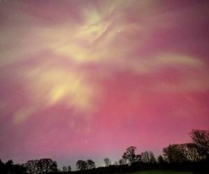 <i>MERCER, MAINE - 10 DE MAYO de 2024: La aurora boreal gira y gira en ondas de color naranja y rosa sobre un pasto de caballos en Mercer, Maine el 10 de mayo de 2024. FOTO Michael Seamans/Getty Images/AFPMichael Seamans / GETTY IMAGES NORTEAMÉRICA / Getty Images vía AFP</i>